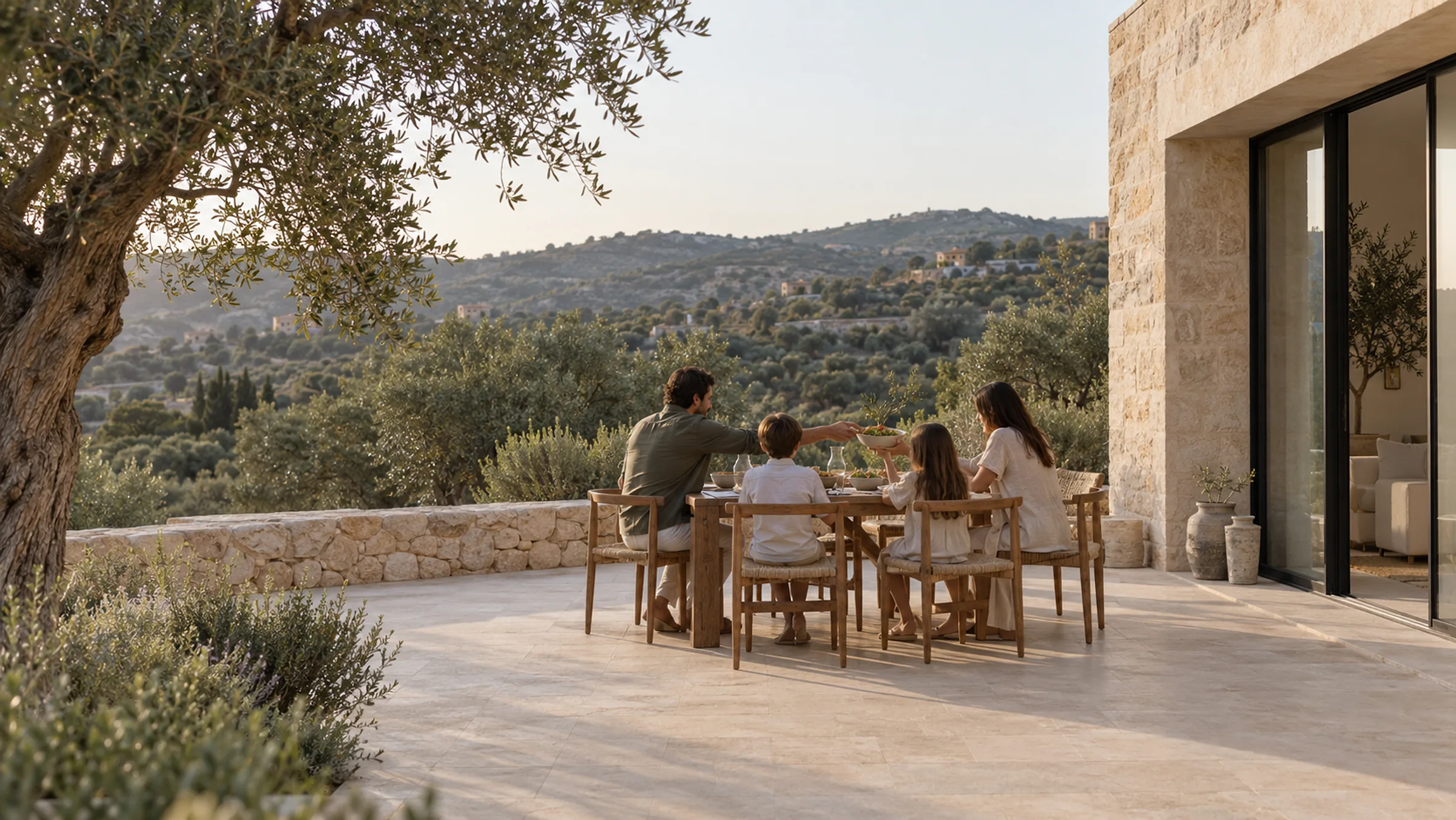 A family at dinner on a stone terrace